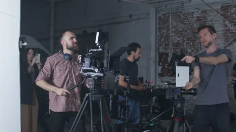 Movie crew using a clapperboard before videographer starts filming a video Stock Footage 198271101