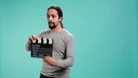 Movie director using clapper on set, filming video production Video stock 319469441