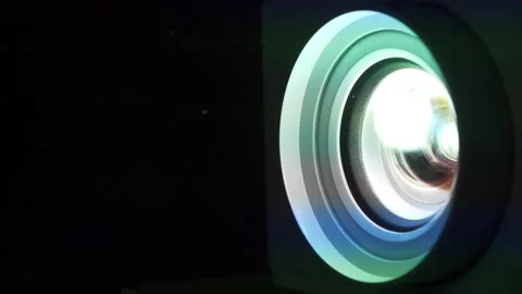Movie is shown through projector. Light passes through lenses. Projector lens Stock-Footage 309646509
