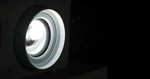Movie is shown through projector. Projector lens in operation in cinema hall Stock Footage 310558000