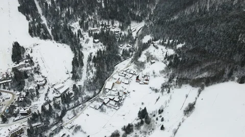 Moving 4K drone flight over the skiing resort village. Aerial winter landscape Stock Footage 174637131