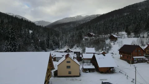 Moving 4K drone flight over the skiing resort village. Aerial winter landscape Stock Footage 178491161