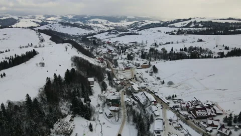 Moving 4K drone flight over the skiing resort village. Aerial winter landscape Stock Footage 178498695