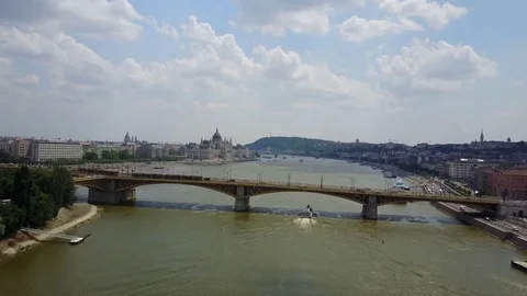 Moving above busy Margit Bridge with tram on the River Danube in Budapest Stock Footage 77109952