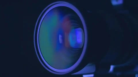 Moving abstract colored patterns reflected in the camera lens. Closeup. Macro Stock Footage 313181749