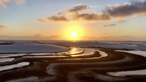Moving Across Interconnected Sunset Waterways in Lençóis Maranhenses Stock Footage 342444973