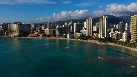 Moving aerial shot flying offshore along Hawaii beach view of Waikiki hotels. Stock Footage