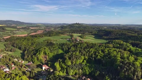 Moving aerial view over patchwork countryside fields and scattered village homes Stock Footage 346262951