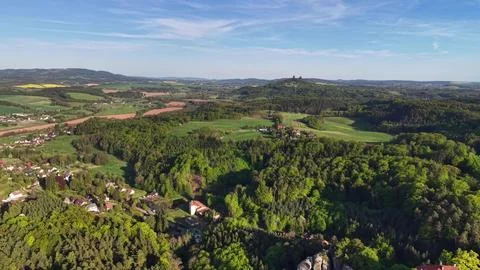 Moving aerial view over patchwork countryside fields and scattered village .. Stock Photos