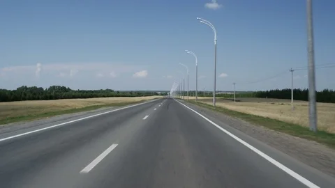 Moving along Asphalt Road Towards Horizon with Trees and Sky Stock Footage
