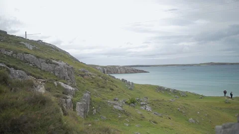 Moving along the cliff side rocks Stock Footage 106854895