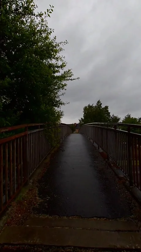 Moving along a narrow overhead bridge - Vertical Video Video stock 200401219