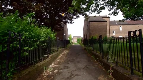 Moving along a narrow path between small buildings Stock Footage 200212988