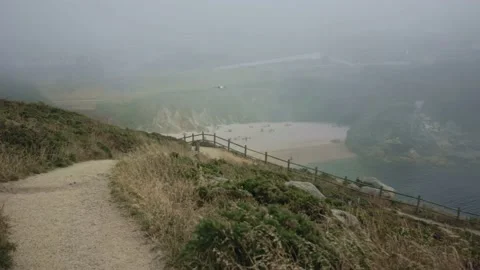 Moving along the path in the mountains at a bird's eye view, overlooking the Stock Footage 232393865