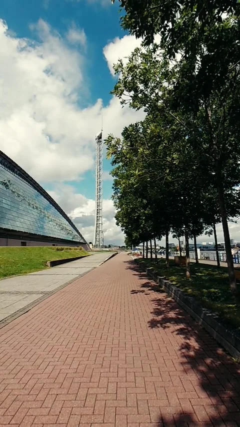 Moving along a red brick path with trees on one side - Vertical Video Video stock 200401190