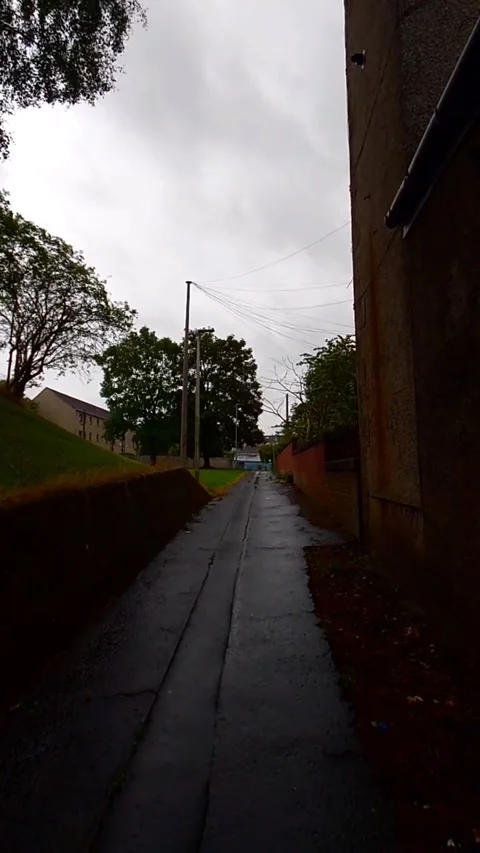 Moving along a side street with building on both sides - Vertical Video Video stock 200401265