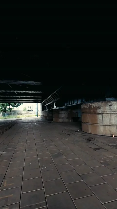 Moving along under an old railway bridge - Vertical Video Stock Footage 200401081