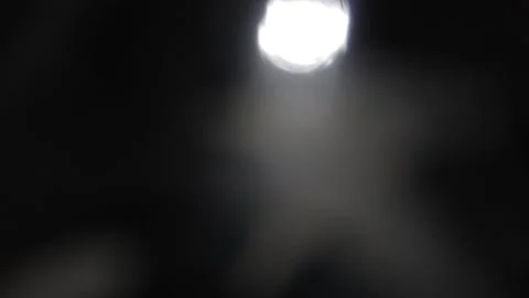 Moving up and down the shiny bokeh light with very few in the blurred background Stockbeeldmateriaal 317478990