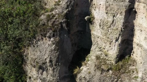 Moving up and sidewards to show a large cliff and the surrounding environment Stock Footage 142755910