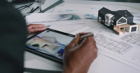 Moving around close-up of an afro engineer designing blueprints on tablet. Stock Footage 241105512