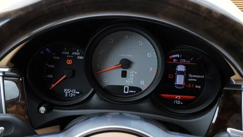 Moving arrow on tachometer in dashboard car while pressing on accelerator pedal Stock-Footage 85830476
