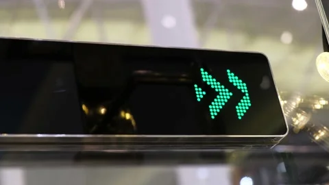 Moving arrows indicate to people direction of movement on the escalator. Stock Footage 133865615