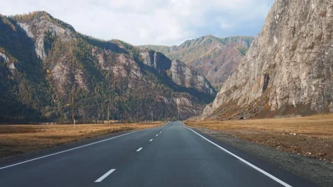 Moving on asphalt road passing through mountain valley in autumn day Stock Footage 290091758