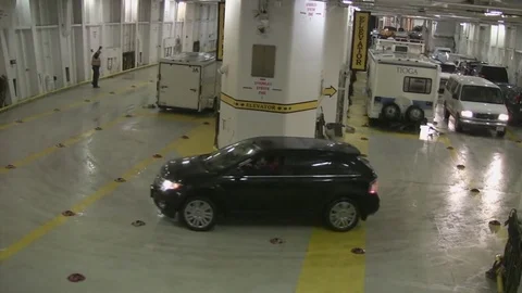 Moving autos in huge parking space on Alaskan ferry. Stock Footage