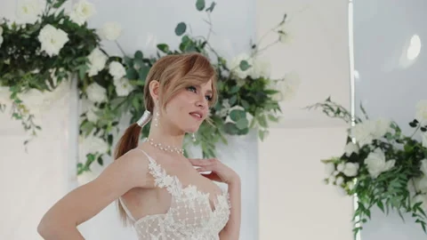 Moving away from the camera from the model in a white dress. Photo shoot of the Stock Footage 219317956