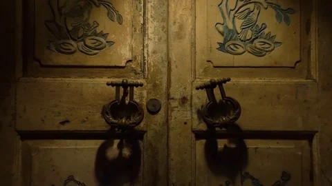 Moving away from the door with large handles and a keyhole in a vintage style. Stock Footage 77616779