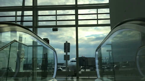 Moving away down escalator from parked aircraft at Munich Airport, Germany Stock Footage 186752200