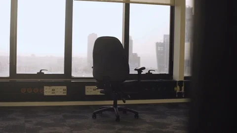 Moving away from empty office with a chair Stock Footage 102458458