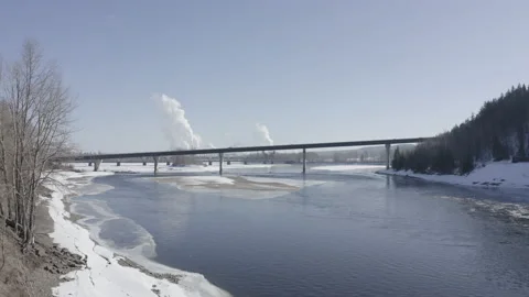 Moving back a Concrete Bridge Over A Small River and Pulp Mill Stock Footage 145963691