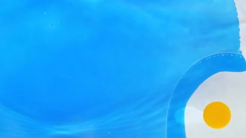 Moving background consisting of blue, yellow particles of the current paint on a Stock Footage 196185198