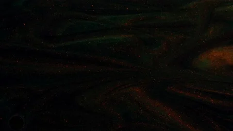 Moving background consisting of red-green-yellow particles flowing on a black Stock Footage 168579453