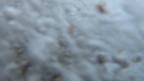 Moving background of the sea wave with many air bubbles rising to the surface of Stock Footage 119653850