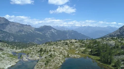 Moving backward above clear blue lake and pine woods in sunny summer day.Europe 動画素材 93194086