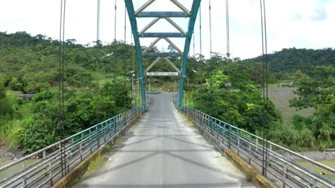 Moving backward between the metal cables of a truss bridge Stock Footage 160320546
