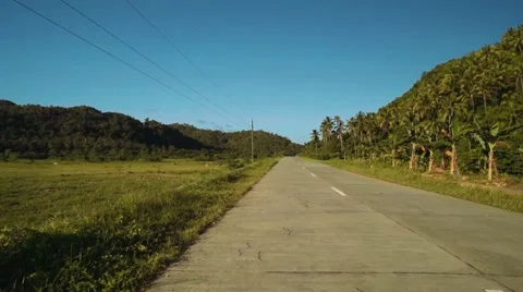 Moving backwards on road through field in Siargao, Philippines Stock-Footage 67601032
