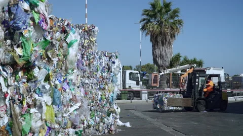 Moving a bale of PLASTIC WASTE Stock Footage 263611794