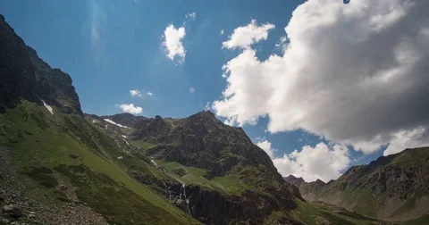 Moving beautiful white clouds over the tops of the Caucasus Mountains Stock Footage 84741272
