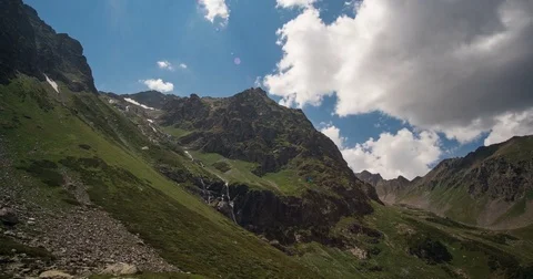 Moving beautiful white clouds over the tops of the Caucasus Mountains Stock Footage 84741645