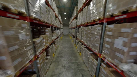 Moving between steel racks full of carton packages FPV Stock Footage 290695006