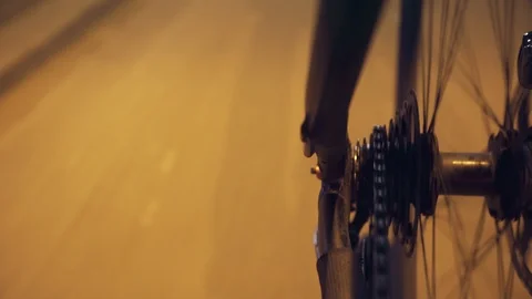 Moving bicycle wheel on a yellow light Stock Footage 87567361