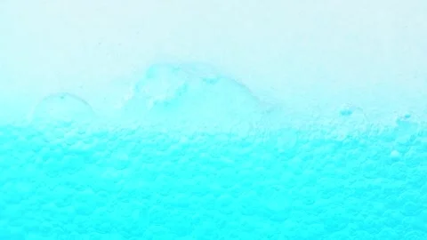 Moving blue bubbles on white background. Cosmetic Essence macro shot Stock Footage 275075523