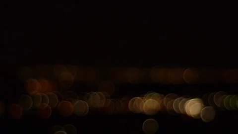 Moving blurred lights on a black background Stock Footage 74570025