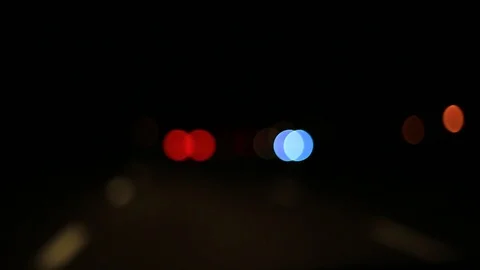 Moving bokeh seen from inside a car driving through the city. Видео 88511918