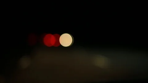Moving bokeh seen from inside a car driving through the city. Stockbeeldmateriaal 88512050