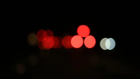 Moving bokeh seen from inside a car driving through the city. Stock Footage 88512184
