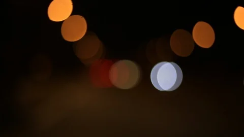 Moving bokeh seen from inside a car driving through the city. Video stock 88512356